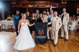 A wedding party holding the Wentworth banner