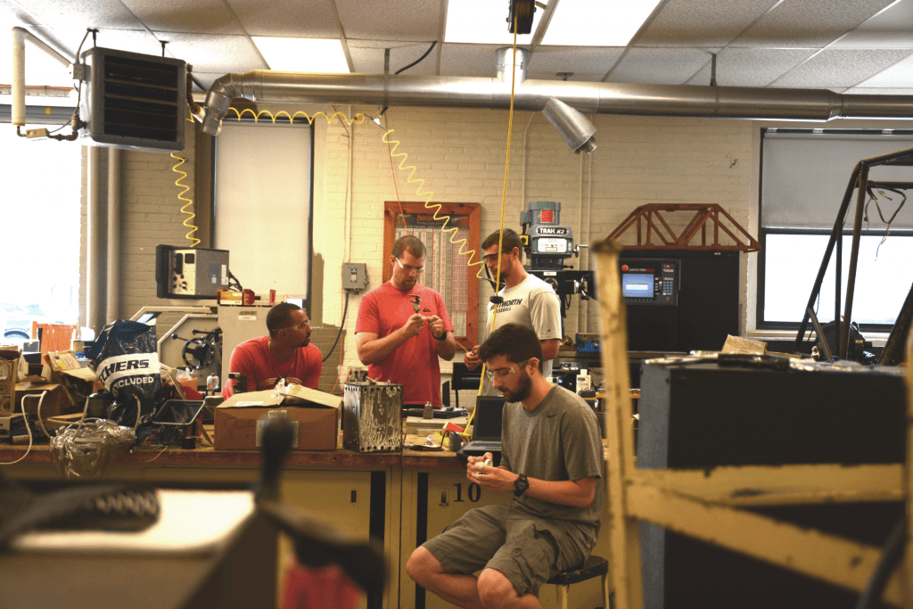 four men working in a projects lab